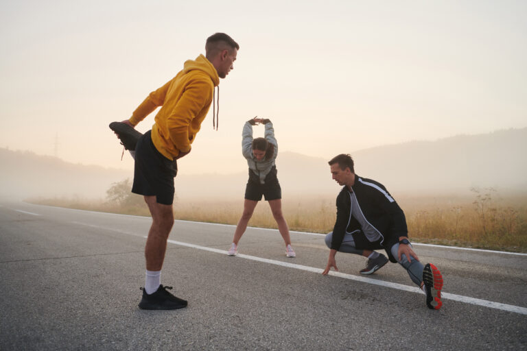 Diverse Athletes Prepare: Dynamic Group Warms Up for Morning Run